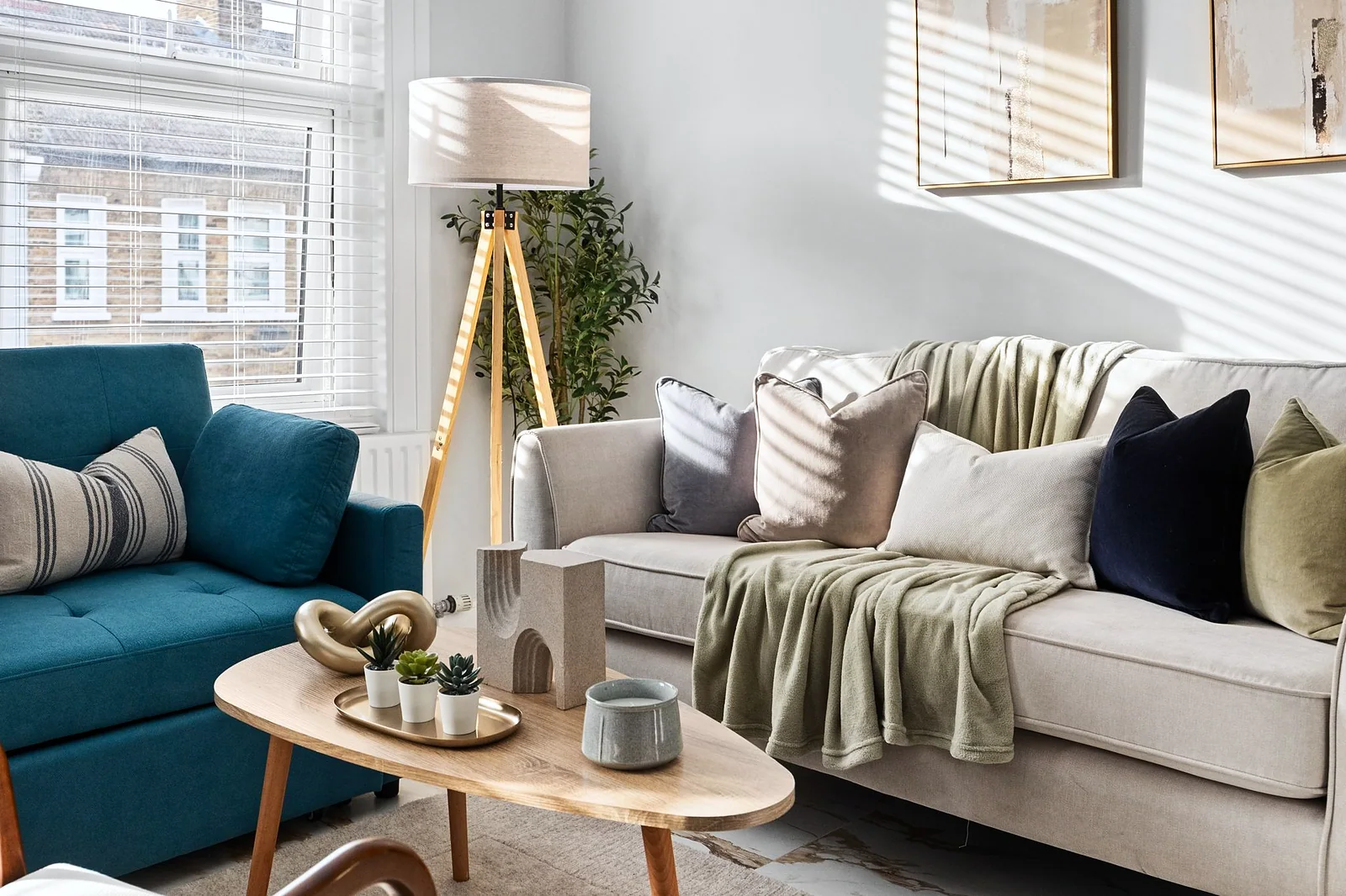 Teal sofa and styled coffee table, interior photography London